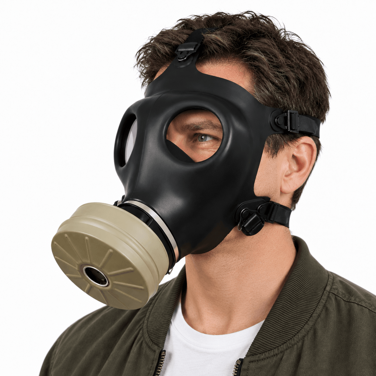 A man wearing a black full-face cbrnmaks.com  gas mask with a beige filter canister, photographed against a clean white background.
